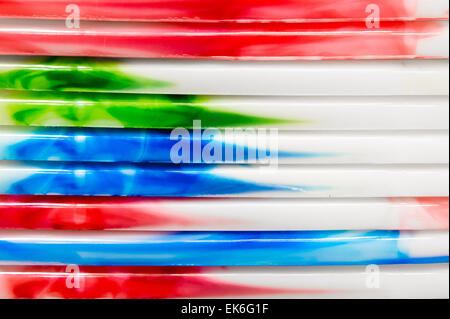 Colorful plastic tubs stacked as a background image Stock Photo
