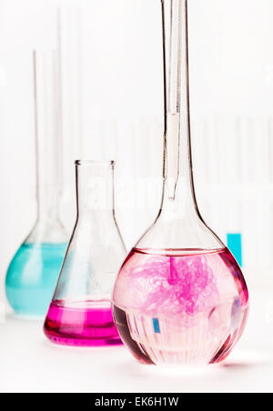 various flasks with reagents on white background Stock Photo