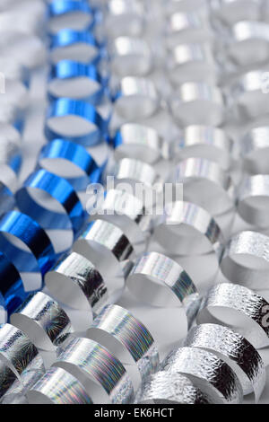 Coiled gift wrap ribbons in silver and blue for a celebration party Stock Photo