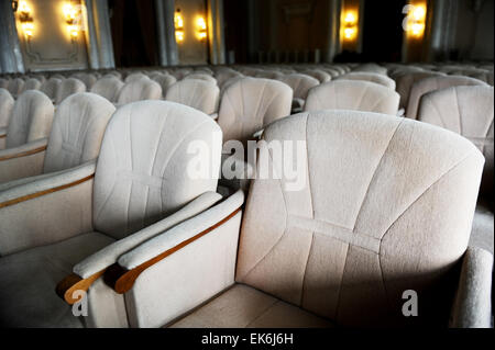 Rows with lots of empty beige velvet armchairs in a big conference room Stock Photo