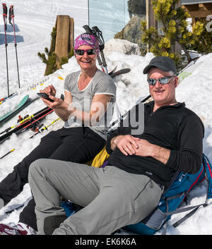 Skiers relaxing outide on winter day, Rifugio Fuciade, Pale di San Martino, Dolomite Mountains, Alps, Italy Stock Photo
