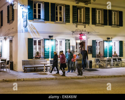 Tourists leaving restaurant in northern Italy Stock Photo