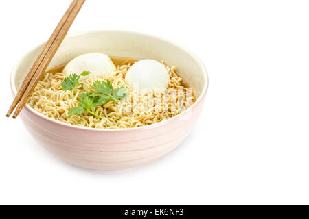 Noodles with boiled eggs in bowl and chopsticks isolated on white background Stock Photo