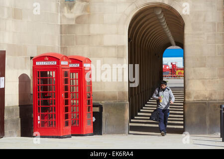 Manchester Town Hall extension arches walkway with red telephone boxes Stock Photo