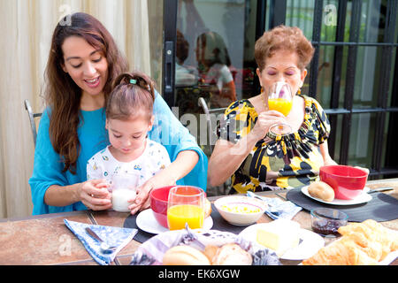 Hispanic family having breakfast together on the outdoor dining showing family bonding time. Stock Photo