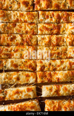 Homemade Cheesy Breadsticks with Marinara Sauce for Dipping Stock Photo