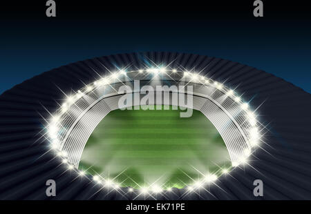 A generic stadium with an unmarked green grass pitch at night under spotlights Stock Photo