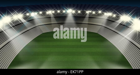 A generic stadium with an unmarked green grass pitch at night under spotlights Stock Photo