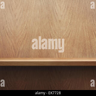 Empty bookshelf or shelf on wooden wall background Stock Photo