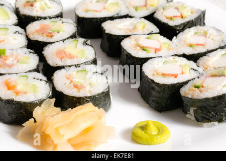 Homemade sushi in a white plate with wasabi and ginger Stock Photo