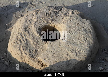 Millstone at the Barbar Temple archaeological site, Barbar, Kingdom of Bahrain Stock Photo