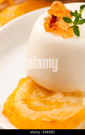 Vanilla Panna Cotta Dessert with lemon and fresh herbs Stock Photo
