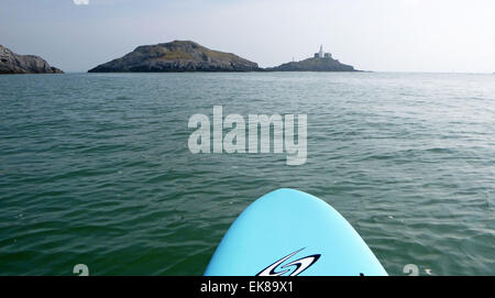 Swansea, UK. 8th April, 2015. The Mumbles Lighthouse off the coast of Swansea this morning as seen from a paddleboard, as people continue to make the most of the warm Easter weather. Credit:  Phil Rees/Alamy Live News Stock Photo