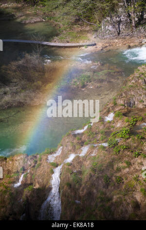 Colourful rainbow over waterfalls and lakes of the National Park Plitvice Lakes, a UNESCO World Heritage Site at Croatia in May Plitvice National Park Stock Photo
