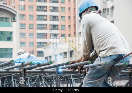 Welders in welding steel bars Stock Photo