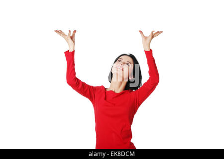 Woman is holding something abstract above her head. Stock Photo