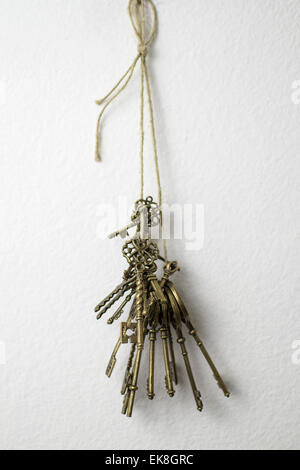 bunch of keys hanging on the white wall Stock Photo