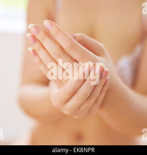 Woman massaging her hands Stock Photo