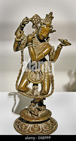 Antique 16th-century bronze sculpture of Lord Krishna playing the flute, originating from Orissa (Odisha), India, representing traditional Hindu sacred art. Stock Photo