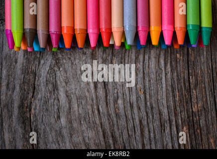 Coloring pencils aligned on wooden background Stock Photo
