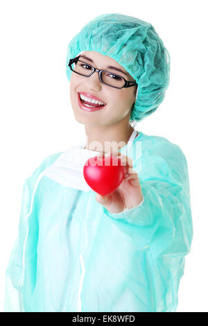 Smiling female doctor or nurse holding heart Stock Photo