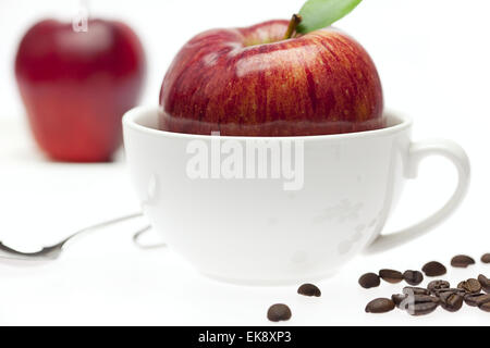 apples in a bowl, spoon and coffee beans isolated on white Stock Photo
