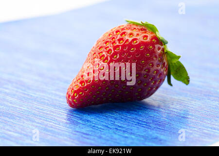 Strawberries on blue paper Stock Photo