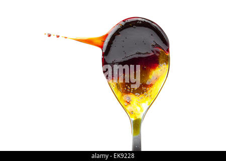 caramel flowing from the spoon isolated on white Stock Photo