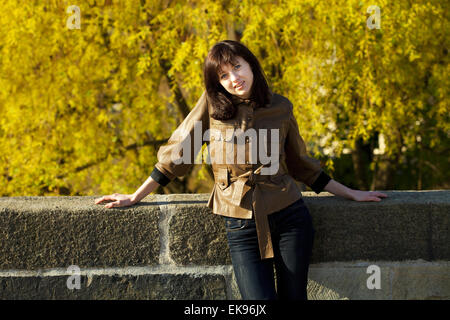 beautiful young woman standing on the bridge Stock Photo