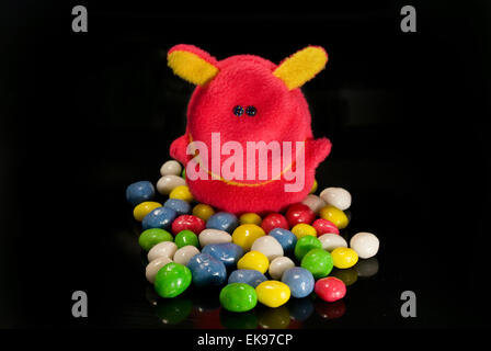 toys and sweets on a black background Stock Photo