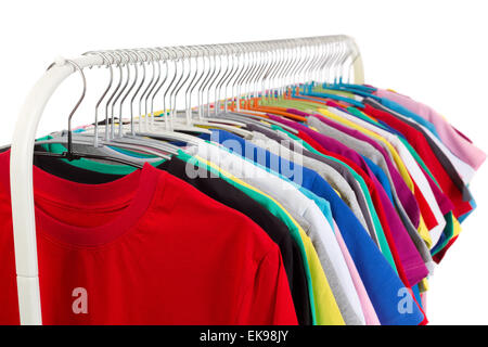 Multi colored shirts on wooden hangers. Isolate on white. Stock Photo