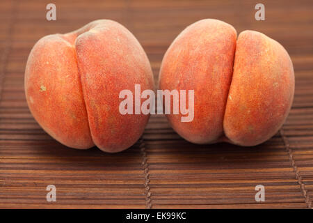 Peach on a bamboo mat Stock Photo