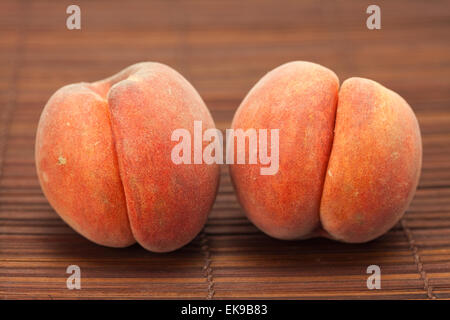 Peach on a bamboo mat Stock Photo