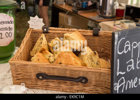 Home made giant scones in wicker basket. Cake stall at Deershed Festival. Stock Photo