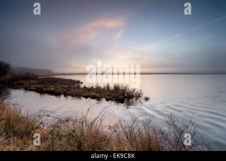 Foggy sunrise over Crowdy reservoir on Bodmin Moor in Cornwall Stock Photo