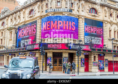 A landscape image of the Shaftesbury Theatre featuring Memphis The Musical and a passing black taxi cab Stock Photo