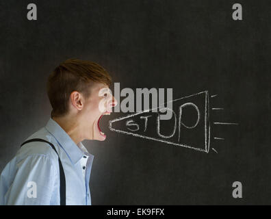 Angry man shouting stop through chalk megaphone blackboard background Stock Photo