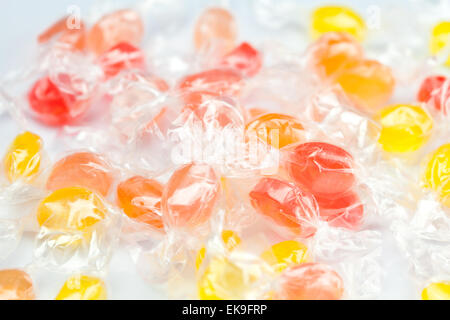 background of multi-colored candies in shiny wrappers Stock Photo