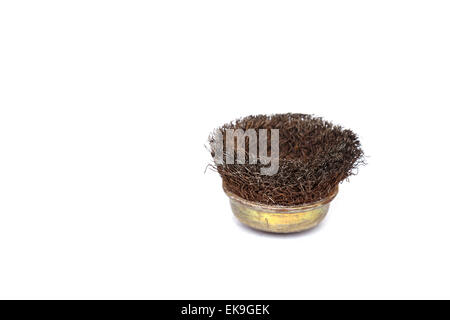 Old rotating metal brush or grinding disk isolated on white background Stock Photo