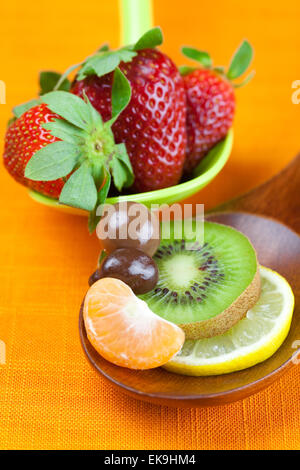 Strawberries, kiwi, mandarin orange, lemon and chocolate candy i Stock Photo