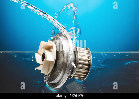 Auto parts, engine cooling pump in water splash on blue gradient background Stock Photo