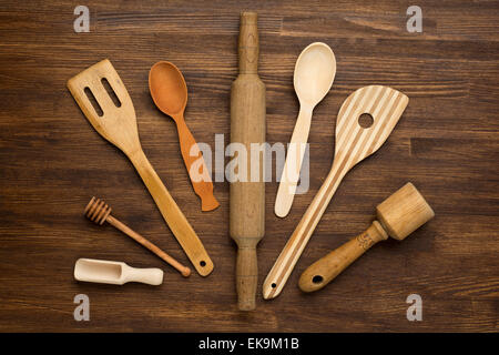 Wooden kitchen tools on vintage wooden background. Stock Photo