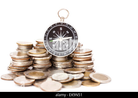 Close up Compass on coin stack Stock Photo