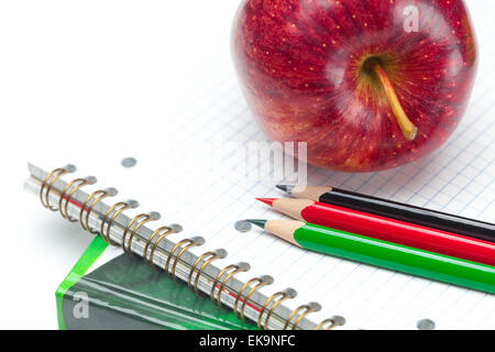 apple, notebooks and pencils isolated on white Stock Photo