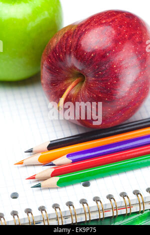 apple, notebooks and pencils isolated on white Stock Photo