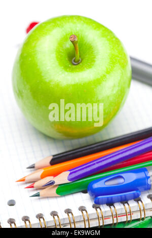 apple, notebooks and pencils isolated on white Stock Photo