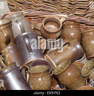 ceramic jugs and cups in a basket at the fair Stock Photo