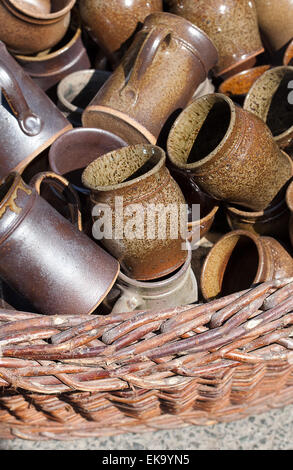 ceramic jugs and cups in a basket at the fair Stock Photo