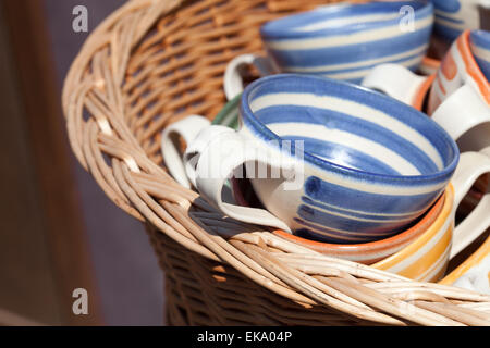 ceramic cups in a basket at the fair Stock Photo