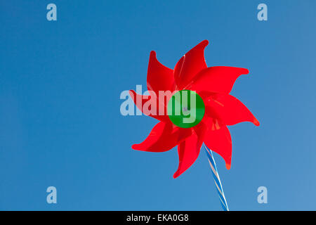toy red windmill against the blue sky Stock Photo
